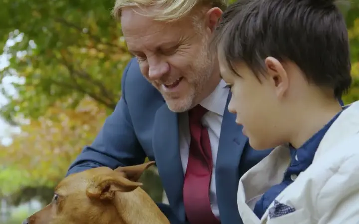 A lawyer with a child in a park, from our video