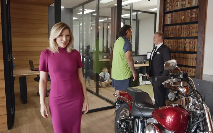 Josh Papalii in the United Legal office with a motorbike, from our TV ad