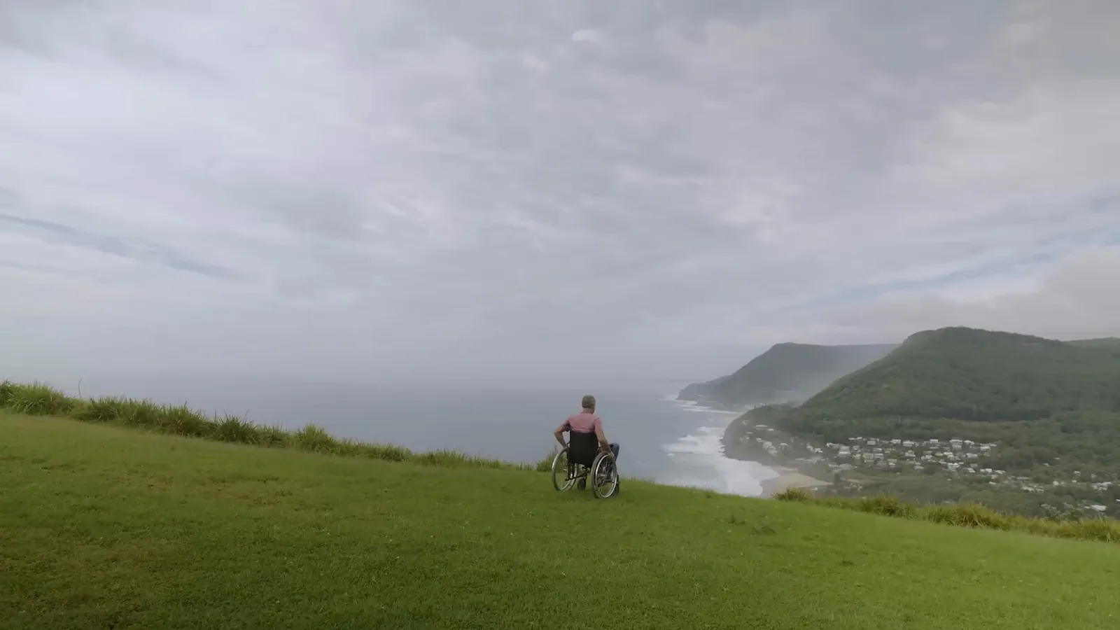 Person in a wheelchair on a grassy headland, critical illness and TPD claims