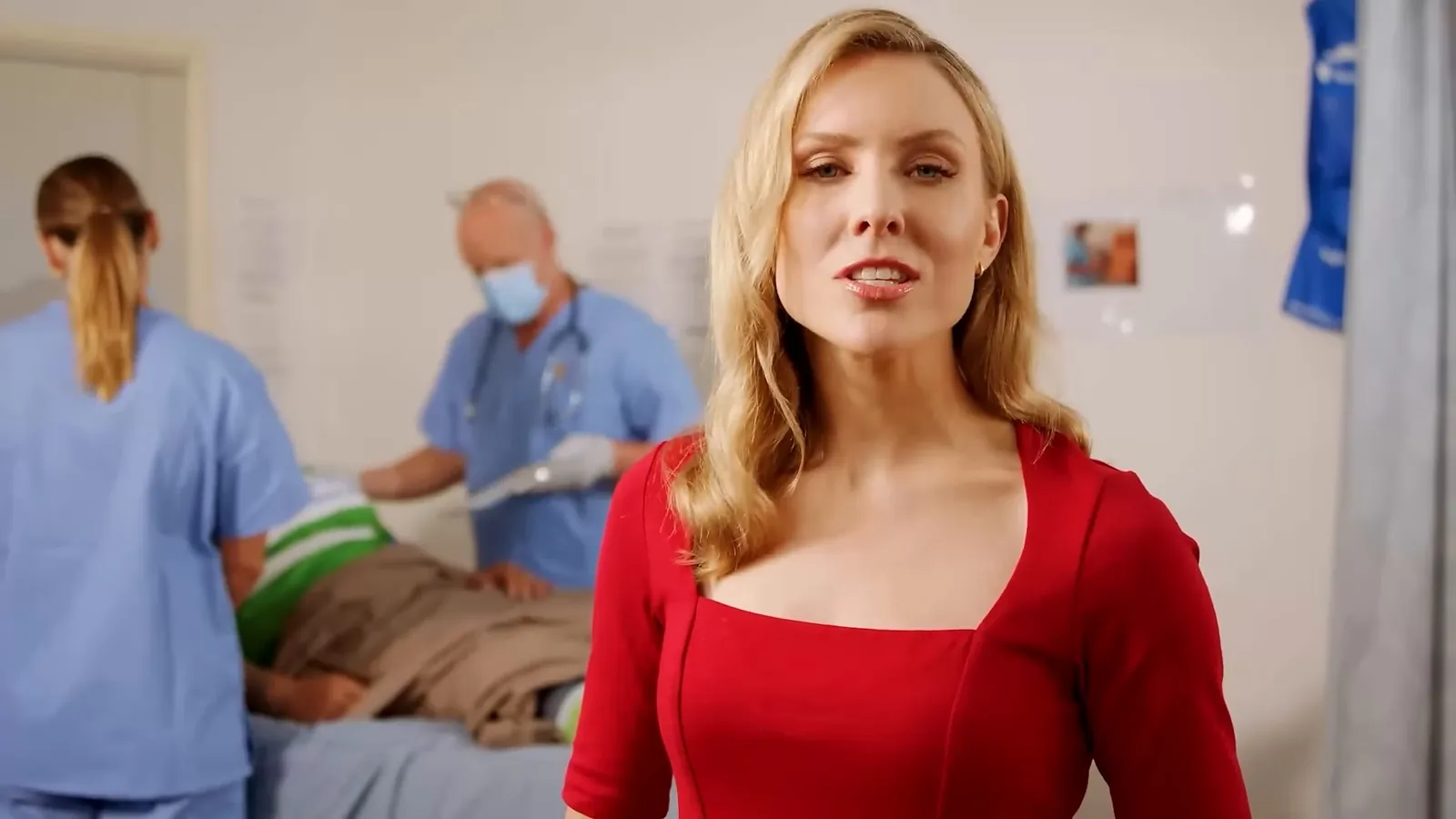 Nurse and doctor caring for a patient on a hospital ward