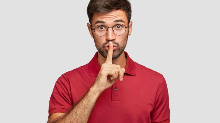 keep-voice-down-attractive-surprised-bearded-male-makes-shush-gesture-demnads-shut-up-wears-casual-bright-red-t-shirt-poses-against-white-wall-people-hush-conspirac-1-scaled.jpg